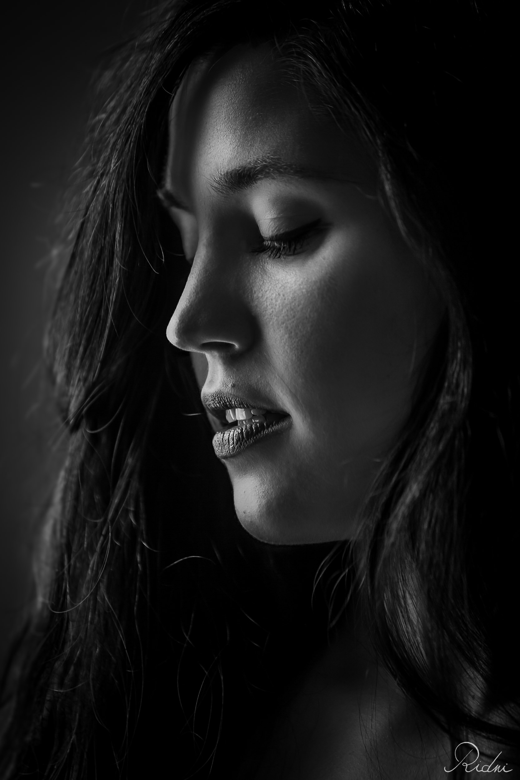 Intimate portrait of a young dark-haired girl in black and white in Ridni studios.